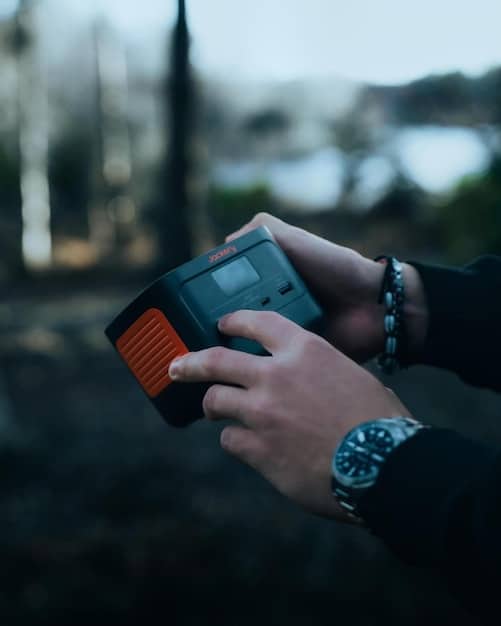 Close-up of a traveler's hand carefully unscrewing a smoke detector in a dimly lit vacation rental room, checking for hidden cameras or recording devices inside. The focus is on attention to detail and careful inspection.