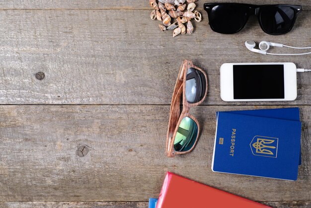 A close-up of travel documents (passport, tickets, insurance policy) laid out on a table, with a coffee cup and a pair of sunglasses. The focus is on preparedness and attention to detail.