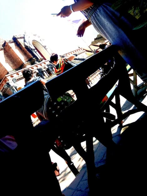 A photo capturing the vibrant atmosphere of a local music festival in Austin, Texas. The image shows a diverse crowd enjoying live music, food vendors selling local cuisine, and colorful decorations enhancing the festive ambiance.