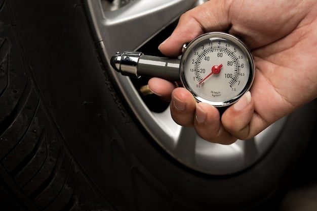 A close-up of a car tire being checked for proper inflation using a digital tire pressure gauge. The background is a well-lit garage.
