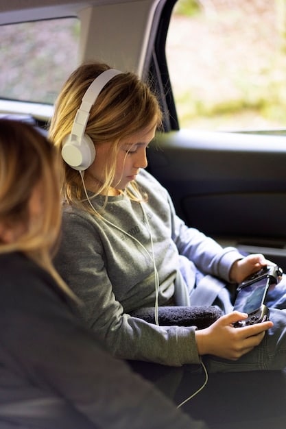 A family sitting in a car on a road trip, all wearing headphones and listening to their own audio content on various devices.