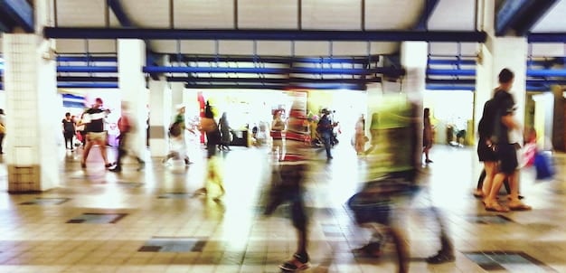 A busy airport terminal with people rushing to catch their flights, showing the hustle and bustle of summer travel.