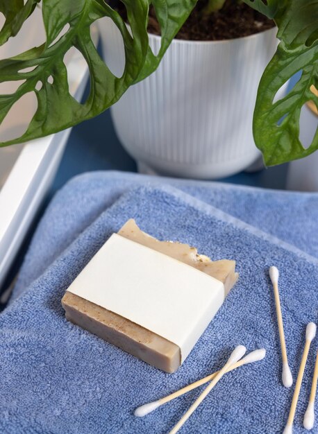 A close-up of a hotel room's eco-friendly amenities, such as refillable soap dispensers, recycled paper notepads, and energy-efficient lighting.