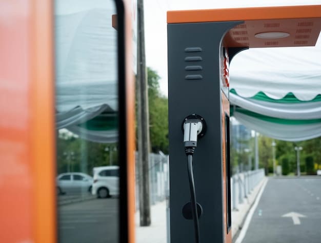 A close-up of an electric car charging station, with a focus on the charging cable and the car's charging port. The background is blurred, showing a modern parking lot with other electric vehicles.