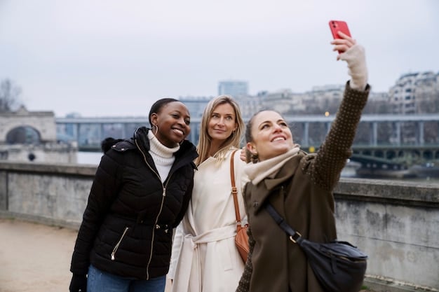 Five diverse travelers are shown laughing and taking selfies with a smartphone in front of the Eiffel Tower in Paris. The composition is candid and portrays joy and connection. The sky is slightly overcast, providing soft, diffused lighting.