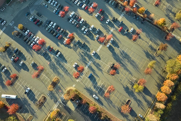 An aerial view of a busy US-Canada land border crossing, showing vehicles lined up at inspection booths, with customs officers conducting inspections. The scene illustrates the process and potential wait times at a typical land border crossing.