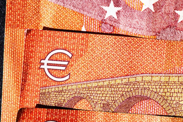A close-up shot of different currency bills from around the world, like US dollars, euros, and yen, scattered on a map of the United States, symbolizing the diverse financial aspects of international travel and tax implications.
