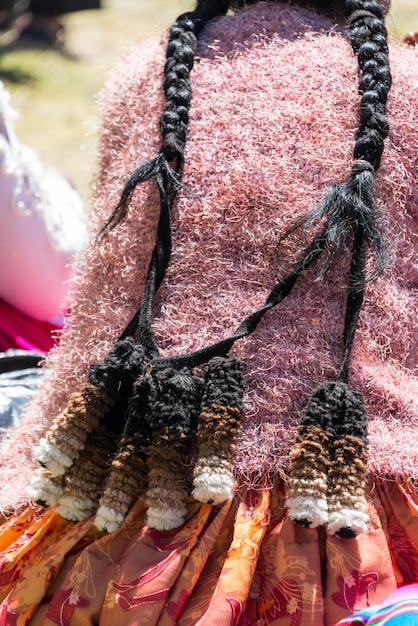 A close-up shot of a Navajo weaver demonstrating traditional weaving techniques to a small group of tourists in Arizona, showcasing the intricate patterns and cultural significance of her work.