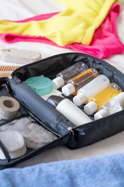 An organized suitcase with neatly folded clothing, reusable water bottles, toiletries in travel-sized containers, and a reusable shopping bag. The suitcase is placed on a wooden surface with a map and a travel guide visible in the background.