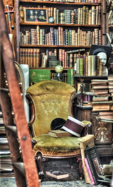 A quaint bookstore in a historic town, filled with shelves of books, comfortable reading chairs, and a local author signing copies of their book. The ambiance is warm and inviting, highlighting the charm of local businesses.