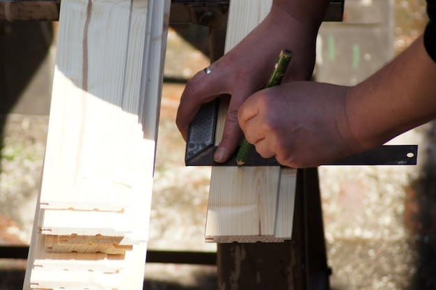 A volunteer hammering nails into a wooden frame of a house during a Habitat for Humanity build, showcasing hands-on work and community involvement.