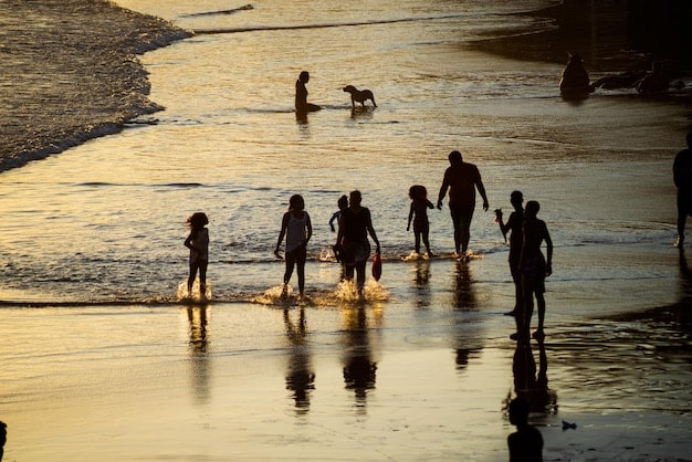 A family enjoying a beach vacation in late October, with fewer crowds and mild weather. The scene captures off-season travel.