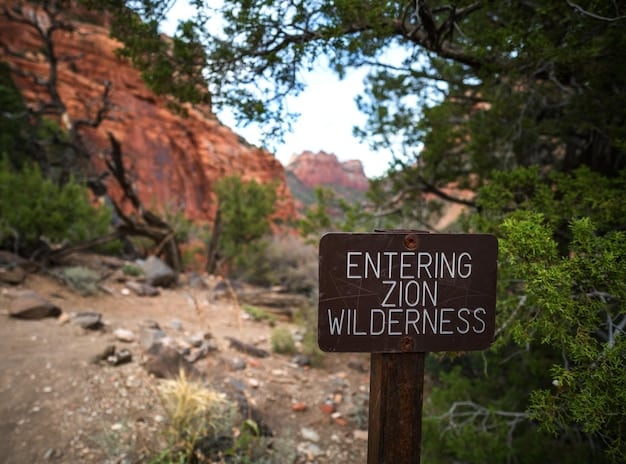 A close-up of a National Park Service sign displaying the current entrance fees. Focus on the numbers and the official NPS logo, providing a clear visual of the costs involved in visiting a national park.